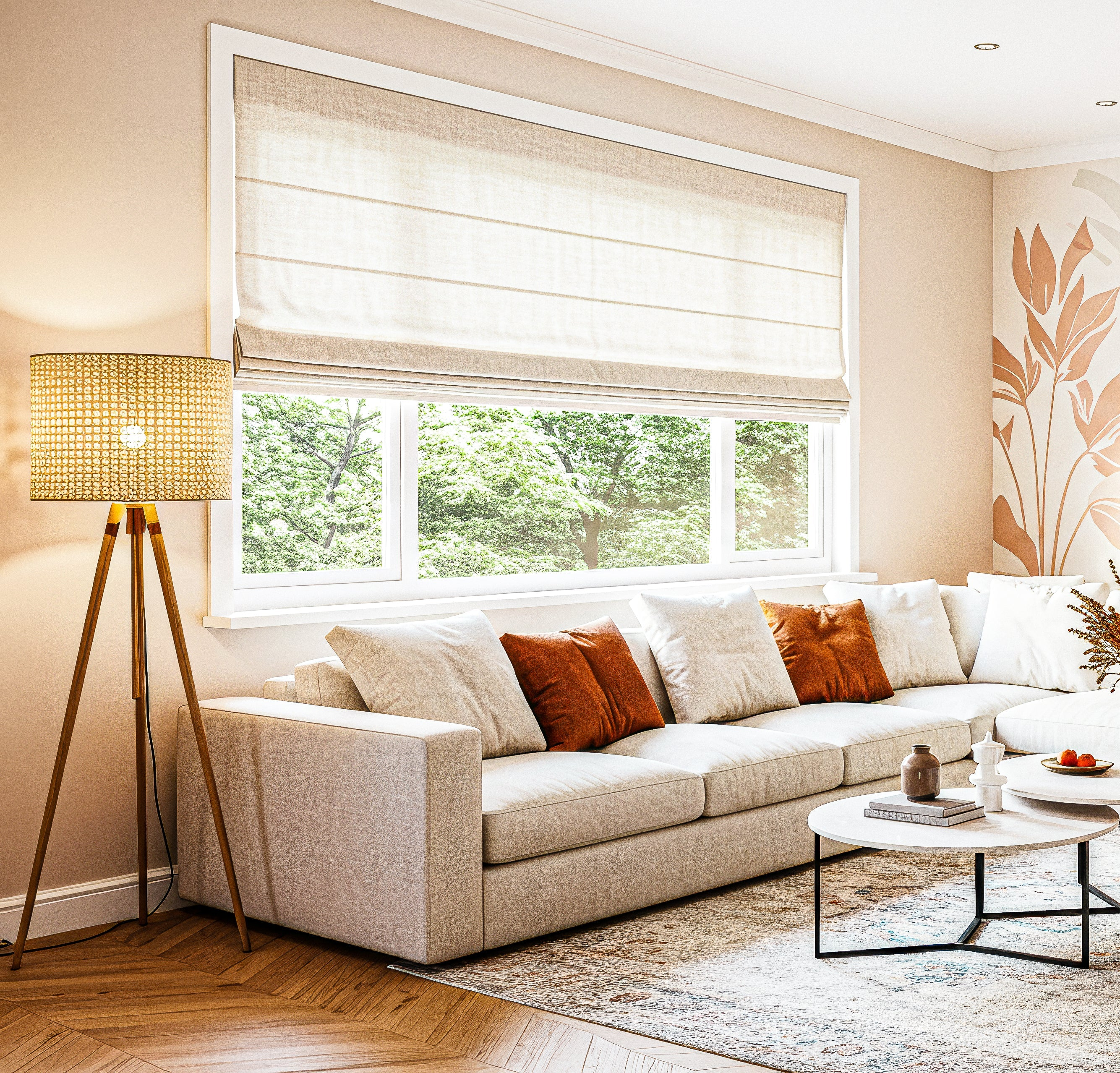 Zandkleurige vouwgordijnen in een moderne woonkamer met een grijze hoekbank, zwarte en beige kussens, grote kamerplant en natuurlijk licht door het raam.
